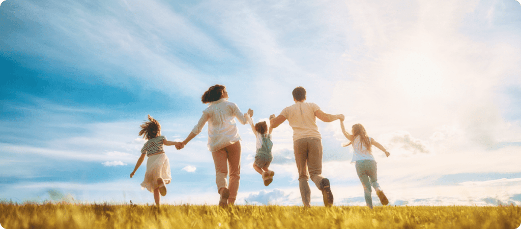 Happy family running in field